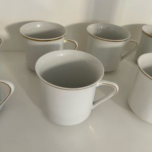 Vintage white ceramic tea cups with gold detail